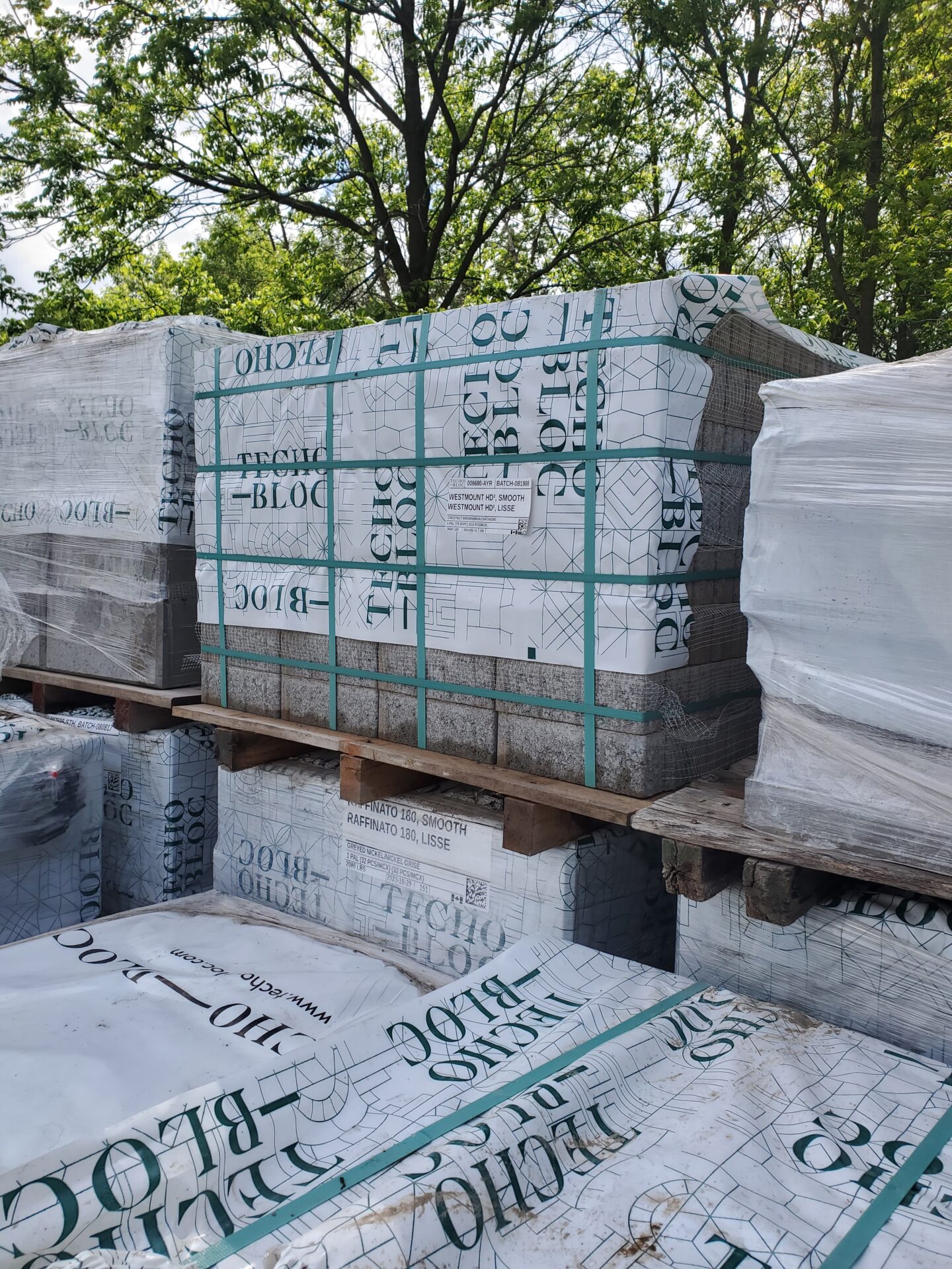 Stacks of wrapped building materials labeled 